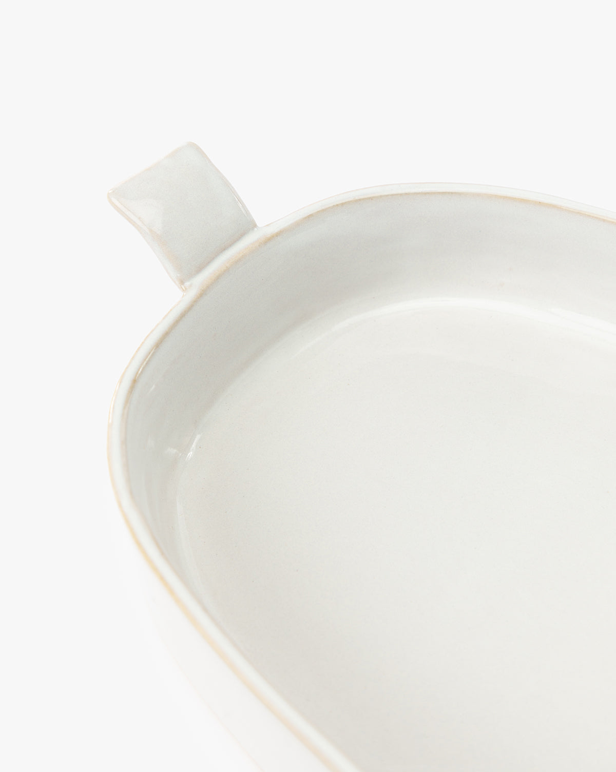 A close-up of the 1.5 Quart Stoneware Baker, featuring a single handle and white ceramic finish, ideal for oven-to-table use, displayed against a plain white background, by Vendixs