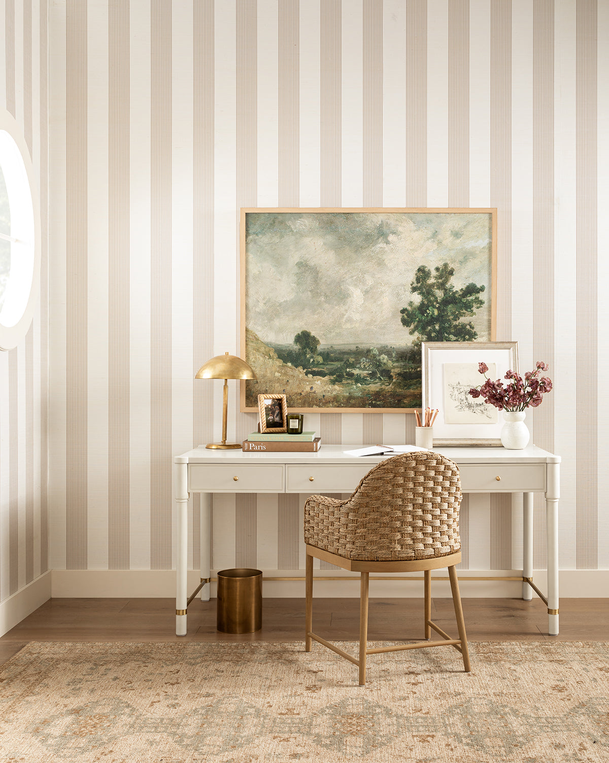 Beige and white striped walls complement the wooden floor covered by the Wilshire Natural Hand-Tufted Wool Rug for comfort and durability, by Vendixs