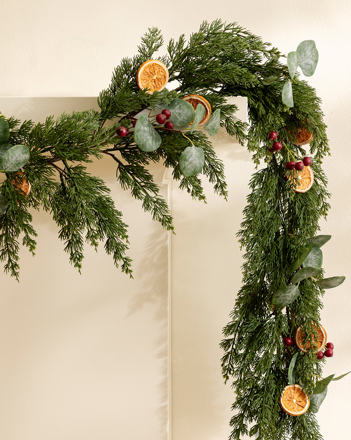 The 6' Orange & Eucalyptus Faux Garland, featuring dried orange slices, red berries, and eucalyptus leaves, adds festive charm to mantels or doorways and is ideal for seasonal decor, by Vendixs