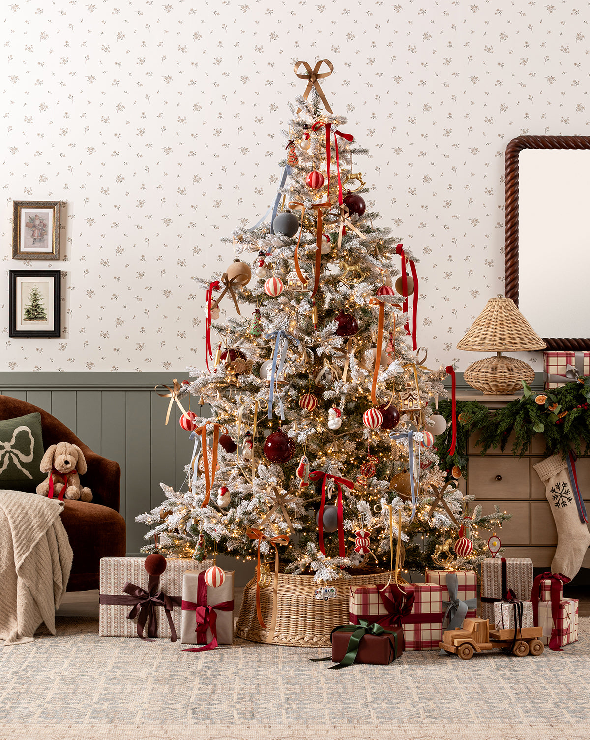 The Magical Wonderland Tree shines in a cozy living room, adorned with red and gold ornaments, ribbons, and lights. Gifts sit below the tree, surrounded by a plush dog toy, vintage wooden toys, gingerbread ornaments, and festive décor, by Vendixs