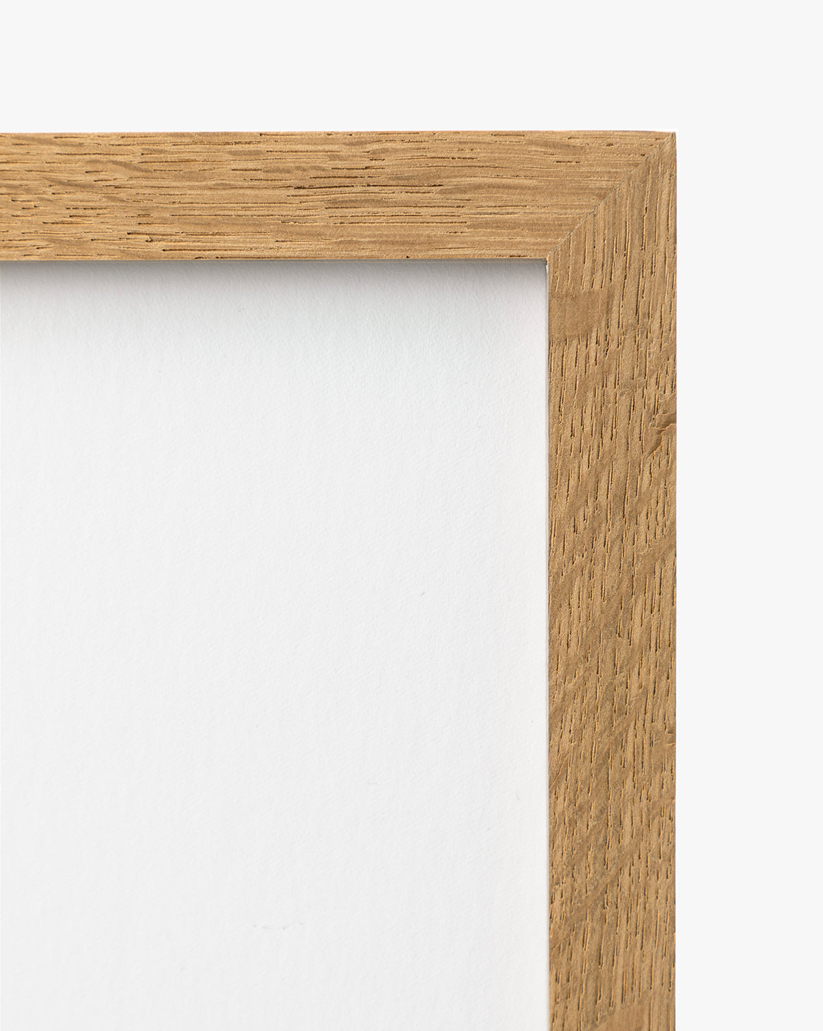 A close-up of the top right corner of the A River Runs Through wooden picture frame showcases its natural grain against a white backdrop, with a white background inside the frame—perfect for highlighting abstract landscapes or earthy tones, by Vendixs