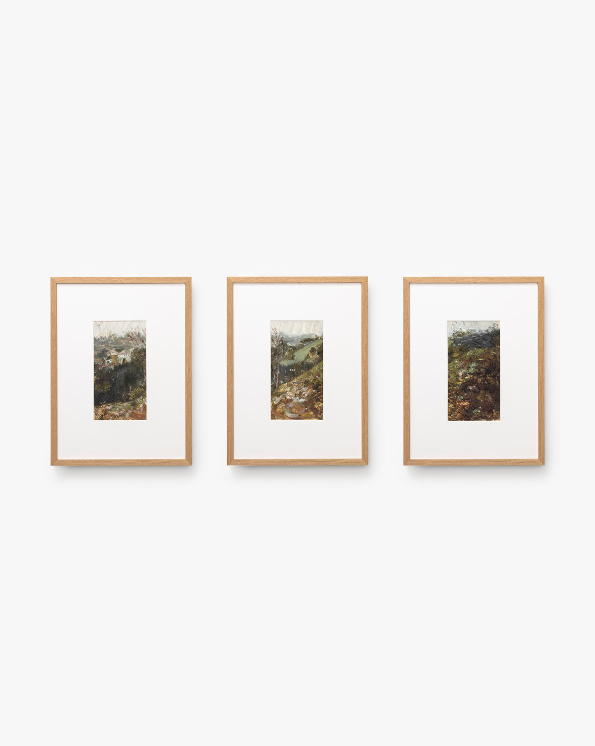 Three A River Runs Through framed abstract landscapes with light wood frames are centered on a white wall. Each features natural scenery in earthy tones, arranged side by side for a striking horizontal display by Vendixs