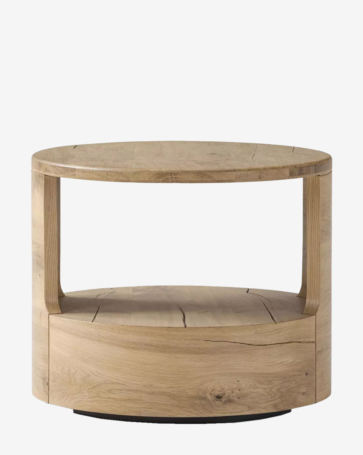 The Adams End Table by Four Hands is a round piece crafted from reclaimed French Oak, featuring an open shelf beneath the tabletop and a natural finish that highlights the wood grain—a stylish, contemporary accent for any space. Vendixs