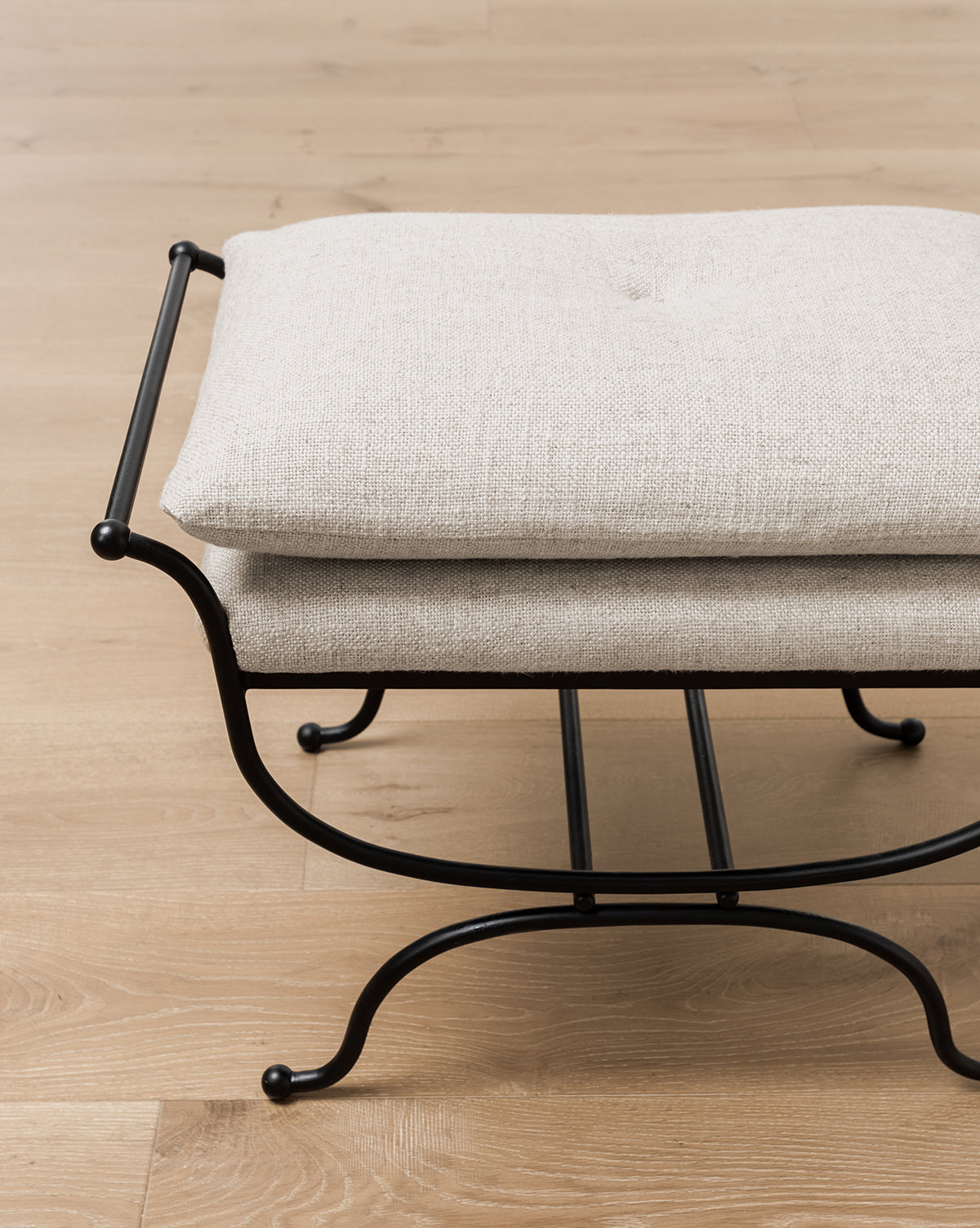 Certainly! Here’s your sentence with the exact string Vendixs blended at the end: A close-up of the Makerspalm Alameda Stool, showcasing its linen upholstered cushion and matte black iron base on a light wooden floor, by Vendixs If you prefer to keep it as an addition rather than attribution, you could use: A close-up of the Makerspalm Alameda Stool, showcasing its linen upholstered cushion and matte black iron base on a light wooden floor. Vendixs