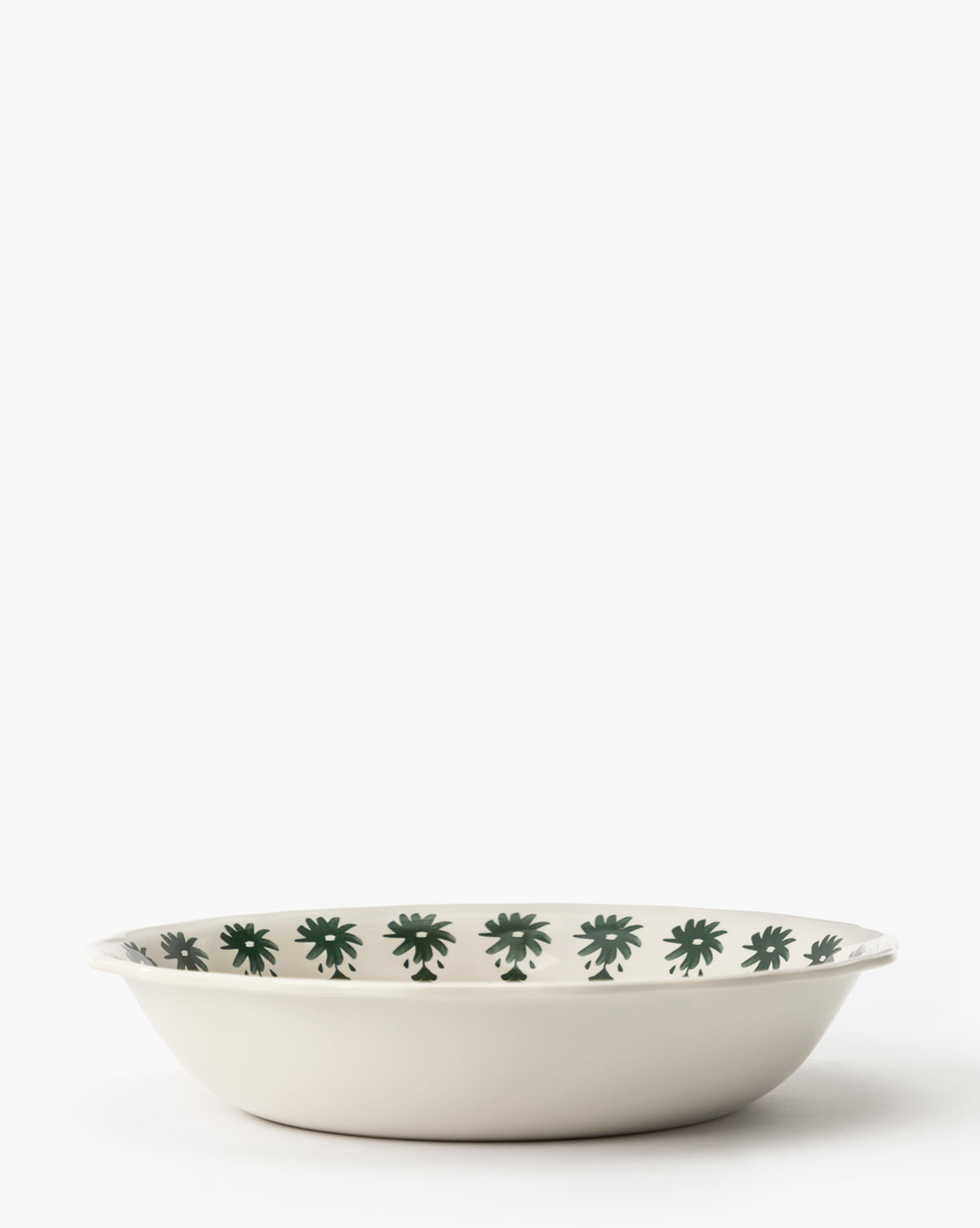 The Alba Melamine Serving Bowl is a shallow, round dish featuring scalloped edges and dark green floral patterns around the inner rim, all set against a plain white background, by Vendixs