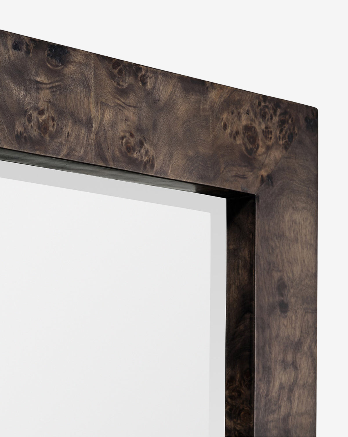Close-up of the top right corner of the Alexia Rectangular Mirror, featuring a thick, dark burl wood frame with a natural grain pattern. This striking statement piece stands out against a plain white background, by Vendixs