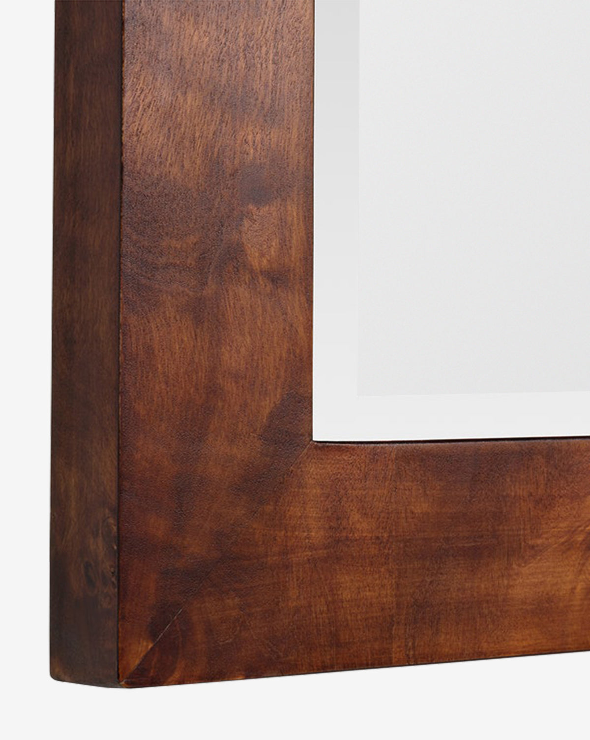 Close-up of the corner of the Alexia Rectangular Mirror, featuring a smooth, polished burl wood frame and a white mat—an elegant statement piece for any space, by Vendixs