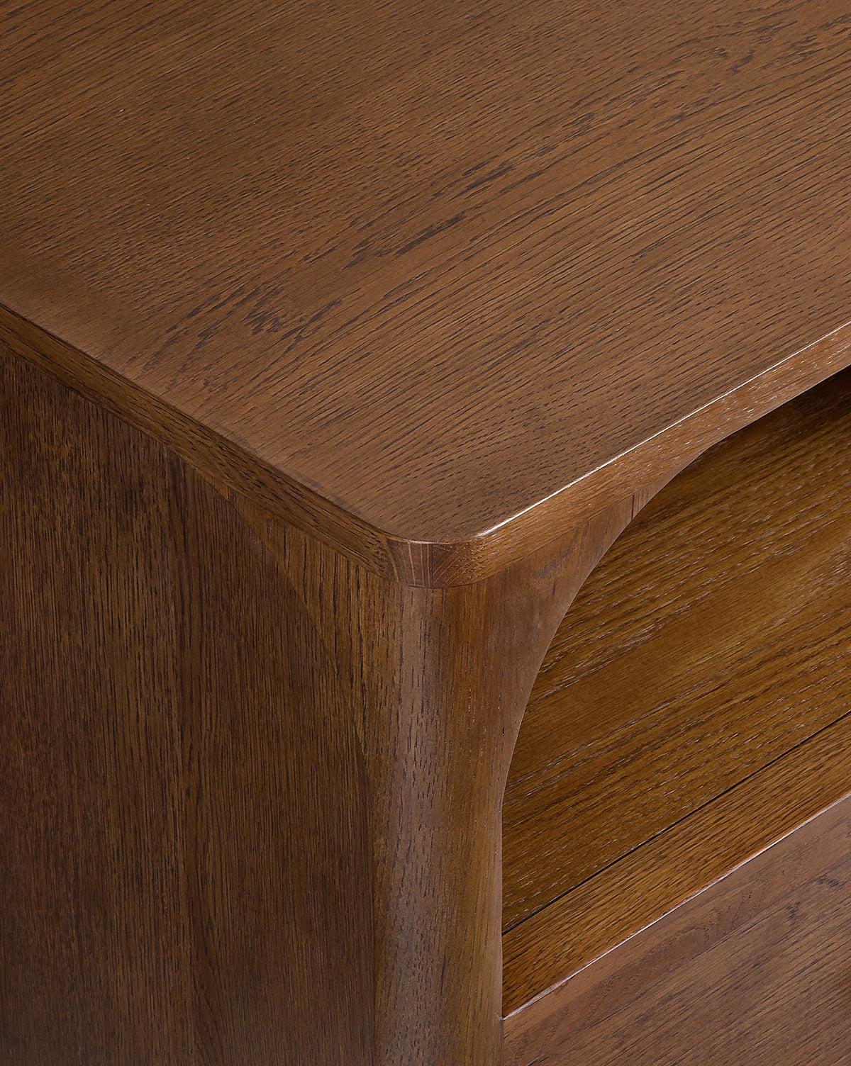 Close-up of the Ambrosia Nightstands corner, highlighting its smooth curved edge and the visible wood grain of its rich brown walnut oak veneer, by Vendixs