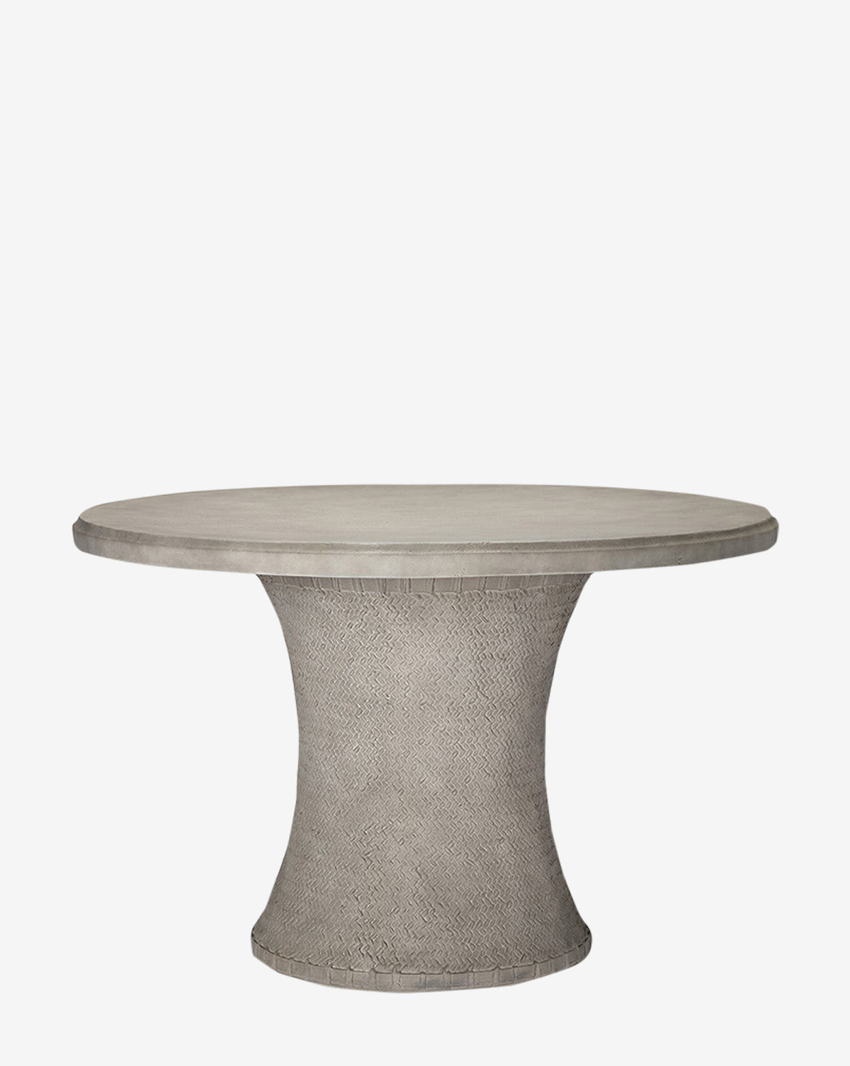The Andrea Dining Table by Made Goods features a round, gray stonecast top and a flared, textured pedestal base with a basket weave design, shown against a plain white background. Vendixs