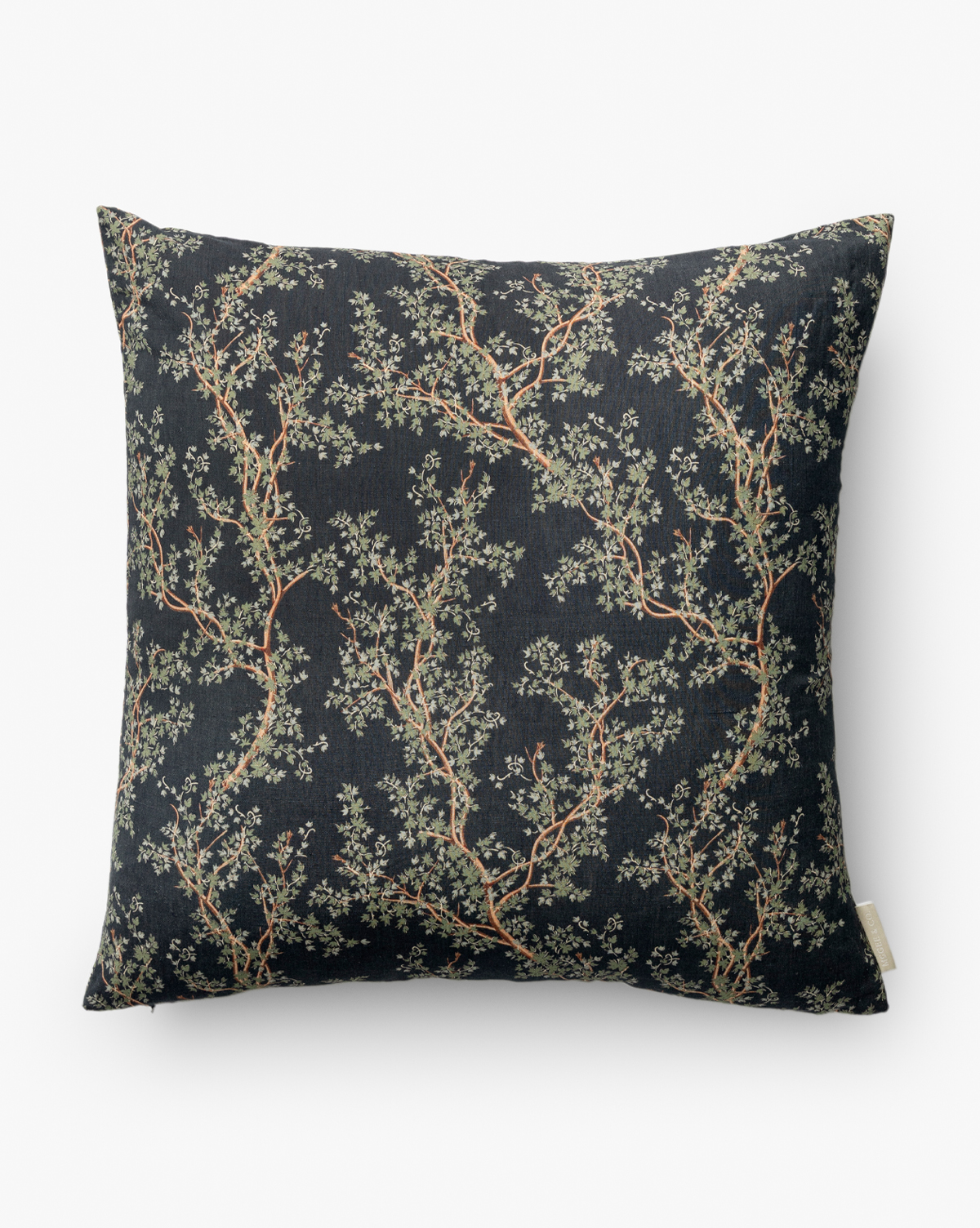 The Antigone Pillow Cover features a dark indigo background with a botanical motif of green and brown leafy branches, adding a natural and elegant touch to any decor, by Vendixs