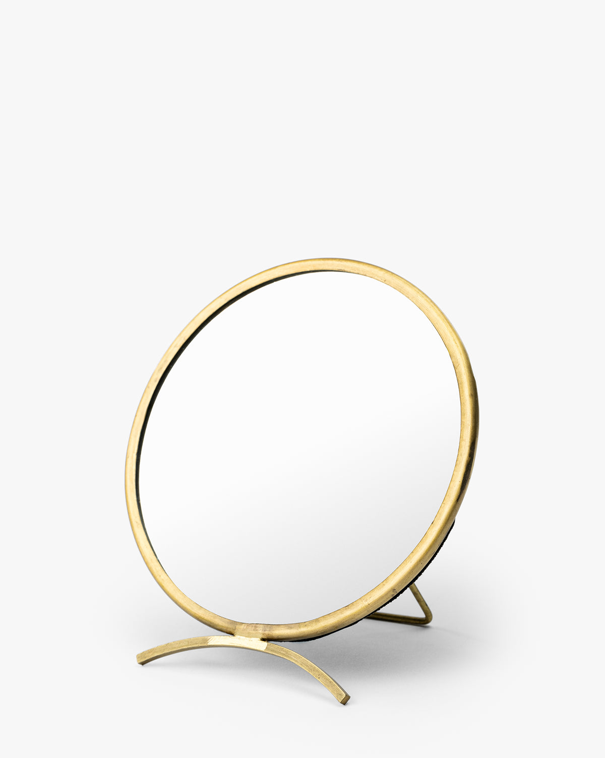 The Antique Brass Folding Mirror is a round tabletop dresser mirror with a brass-finished frame and stand, shown at a slight angle on a plain white background by Vendixs