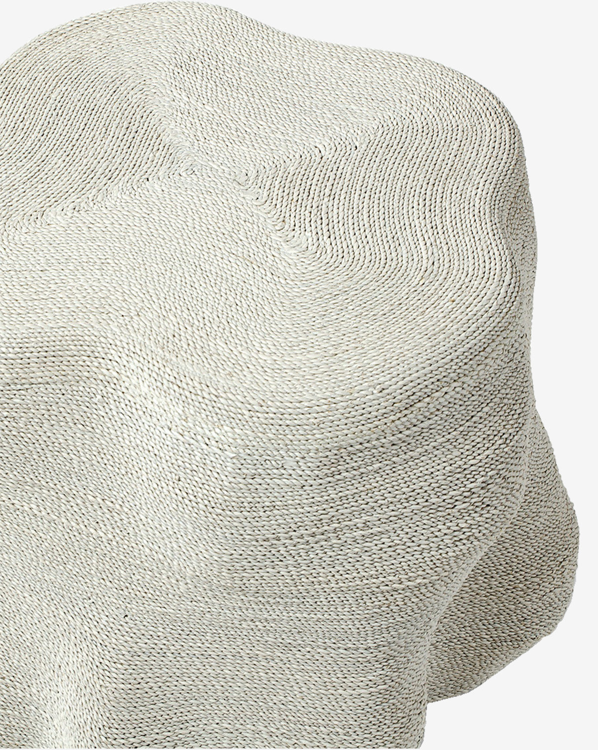 The Aphra Side Table features sculptural curves and folds, wrapped in light beige textured knit fabric with visible stitches—its soft material and organic shape make it an ideal accent piece for stylish living rooms, by Vendixs