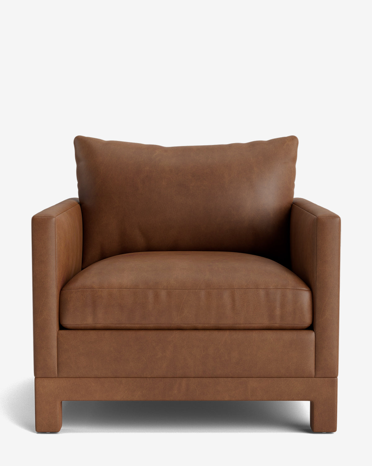 The Appoline Lounge Chair from our Upholstery Collection features wide, boxy arms, brown leather upholstery, thick seat and plush back cushions, by McGee & Co. Made to order for your space; shown here against a plain white background.