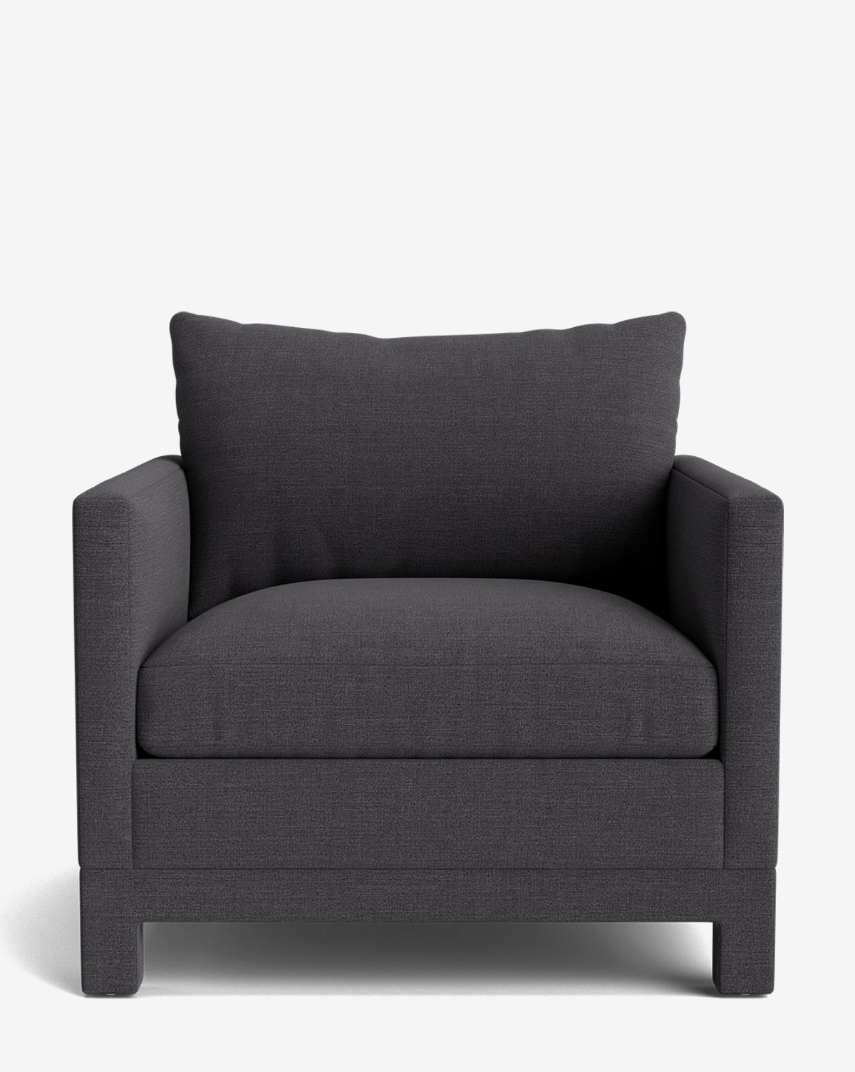 The Appoline Lounge Chair from our Upholstery Collection is a made-to-order dark gray armchair with wide cushioned arms, a plush seat, and a matching backrest pillow, showcased against a clean white background by McGee & Co.