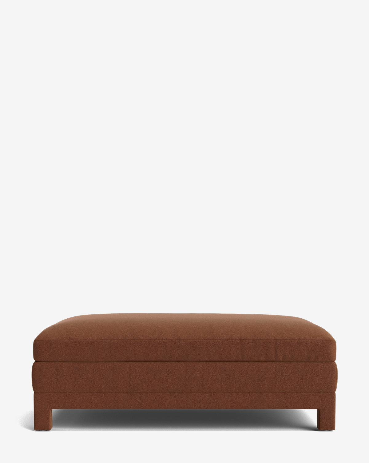 The Appoline Ottoman is a modern rectangular piece, upholstered in brown fabric with short block legs, and is shown against a plain white background by McGee & Co.