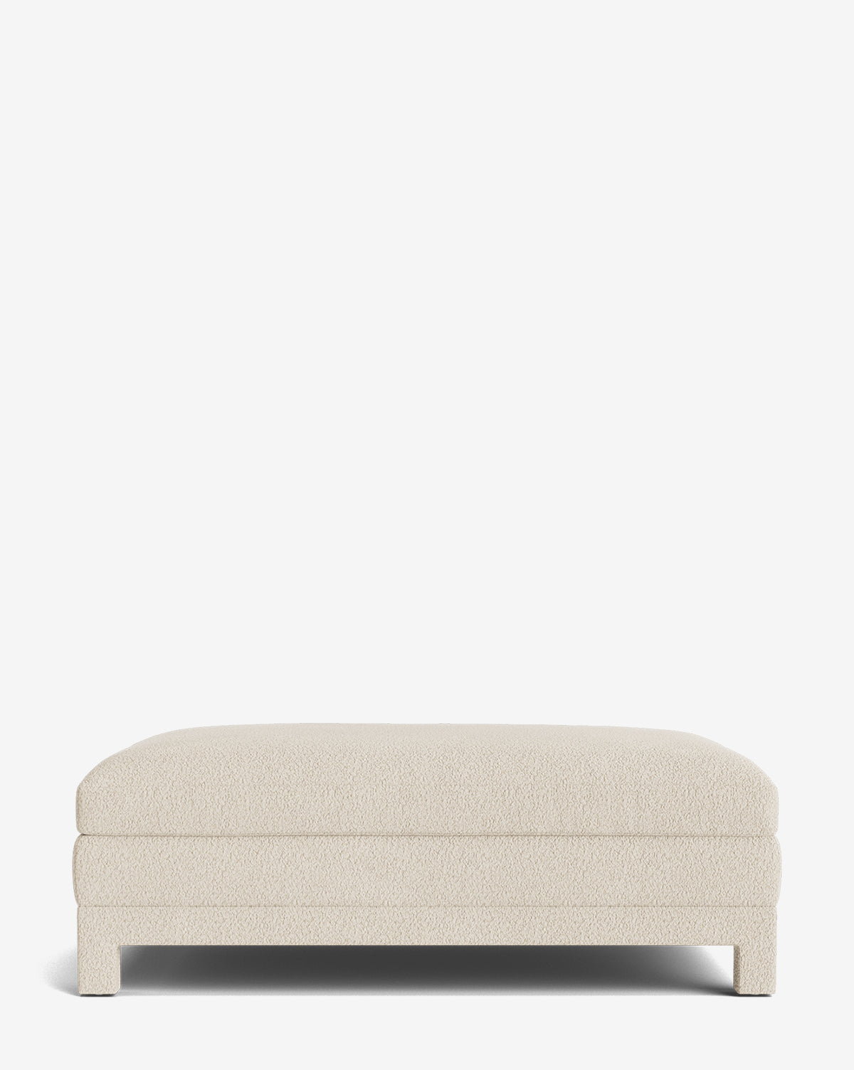 The Appoline Ottoman is a modern, cream-colored piece featuring plush, textured upholstery and short legs, displayed against a plain white background by McGee & Co.