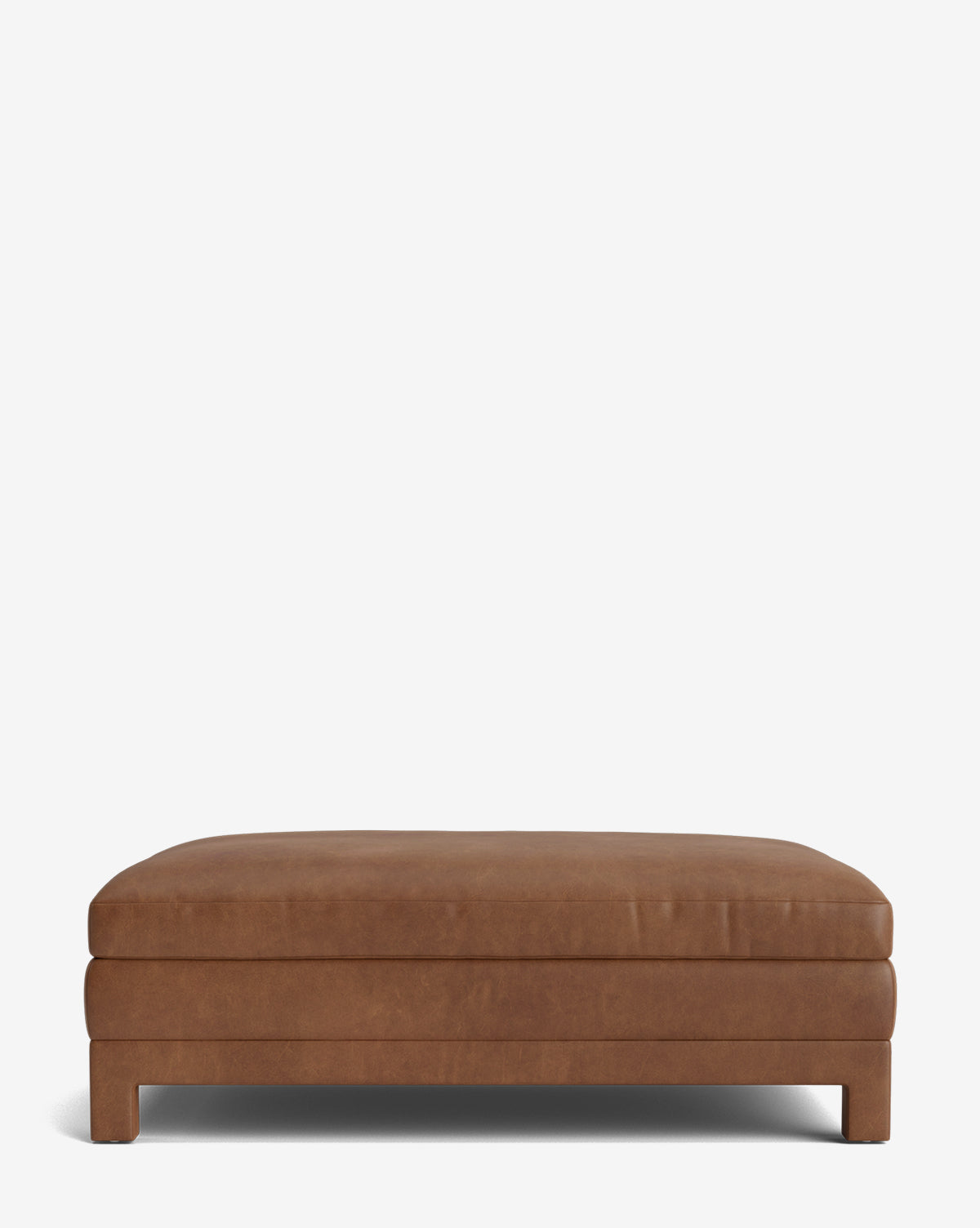 The Appoline Ottoman is a rectangular, low-profile modern piece in brown leather, featuring a minimalist design, flat top, and four short legs, displayed against a plain white background by Vendixs