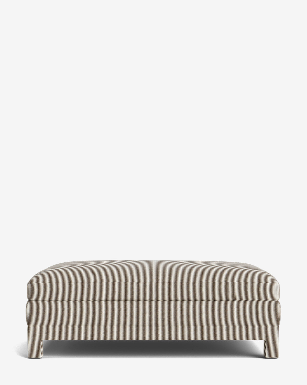 The Appoline Ottoman is a rectangular, modern piece with short legs and light gray upholstery featuring thin vertical stripes, shown against a plain white background by McGee & Co.
