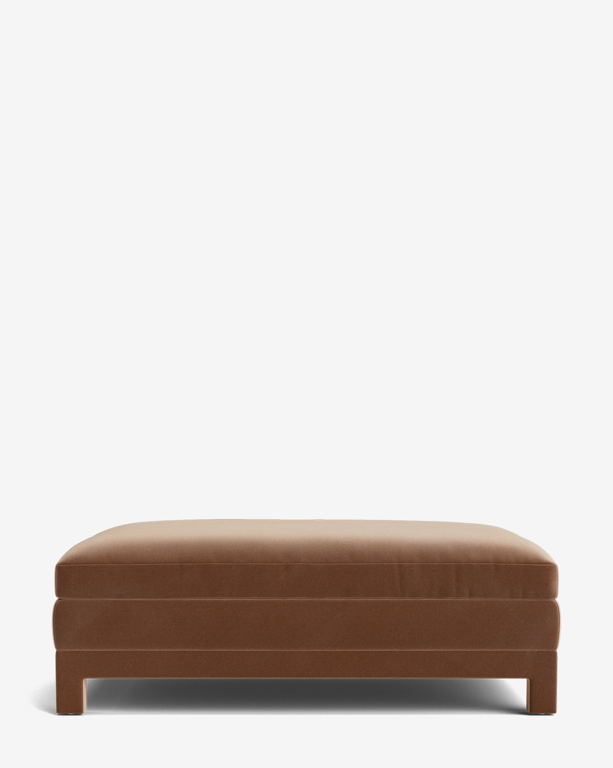 The Appoline Ottoman is a rectangular, brown upholstered piece with a simple, modern design and low legs, shown against a plain white background by McGee & Co.