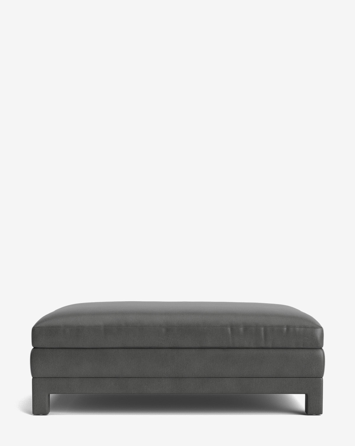 The Appoline Ottoman is a modern, rectangular piece with dark gray upholstery, a flat cushioned top, and low wooden legs, displayed against a plain white background by McGee & Co.