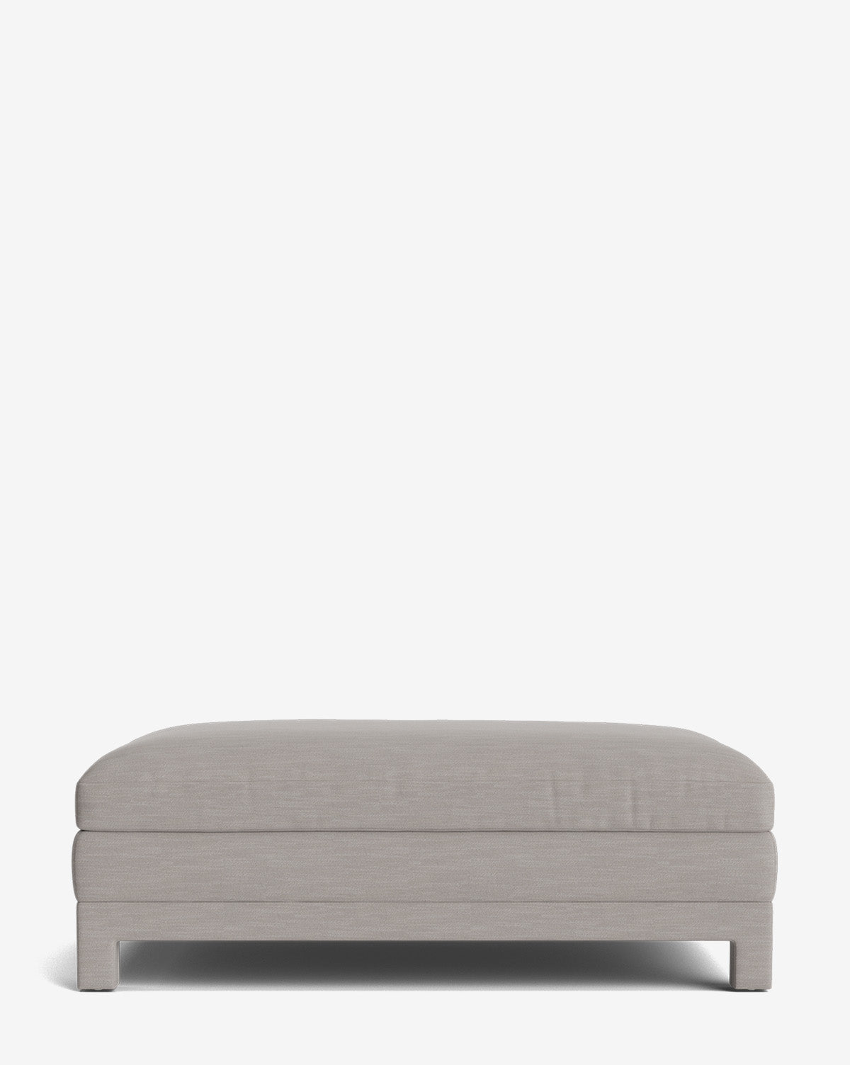 The Appoline Ottoman is a rectangular, light gray upholstered piece featuring a cushioned top and short square legs, shown against a plain white background by McGee & Co.