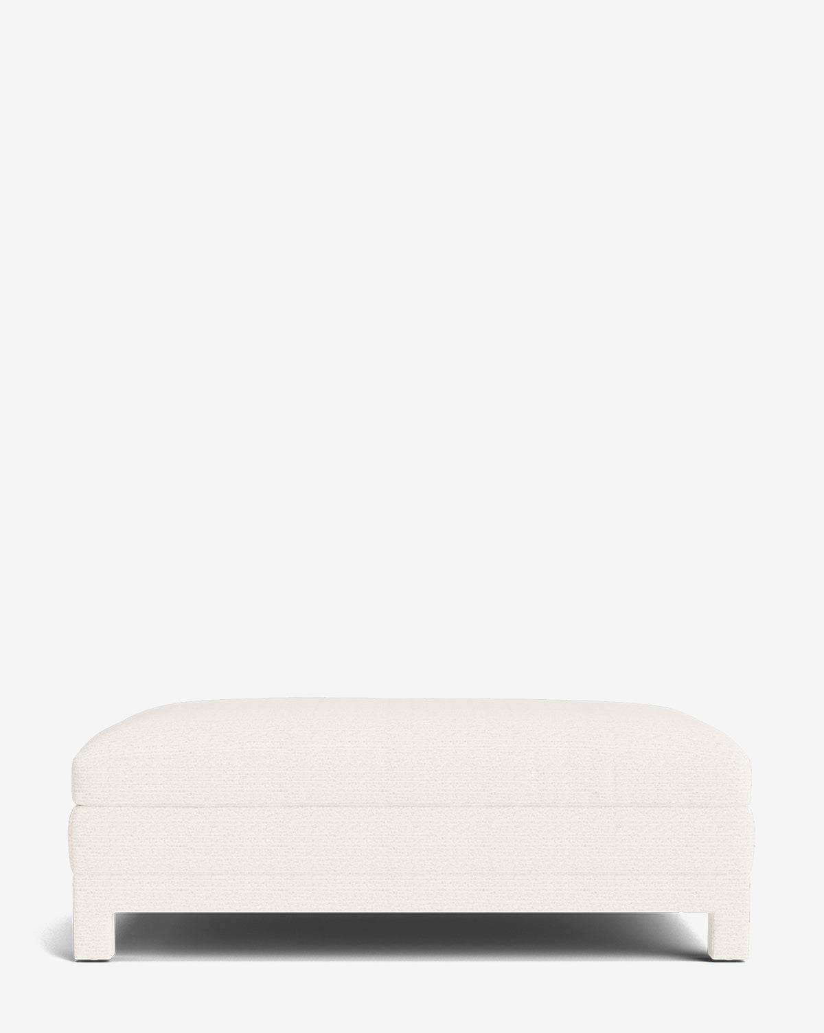 The Appoline Ottoman is a large, rectangular modern piece upholstered in white fabric with short legs, shown from the front on a plain white background by McGee & Co.