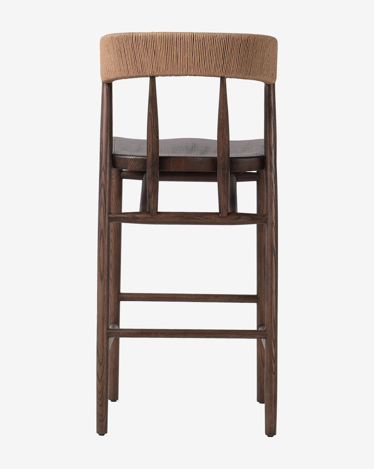 The Ardent Stool by Four Hands features a curved natural paper rush woven backrest with three vertical supports and a dark oak frame, showcased from the back against a white background. Vendixs