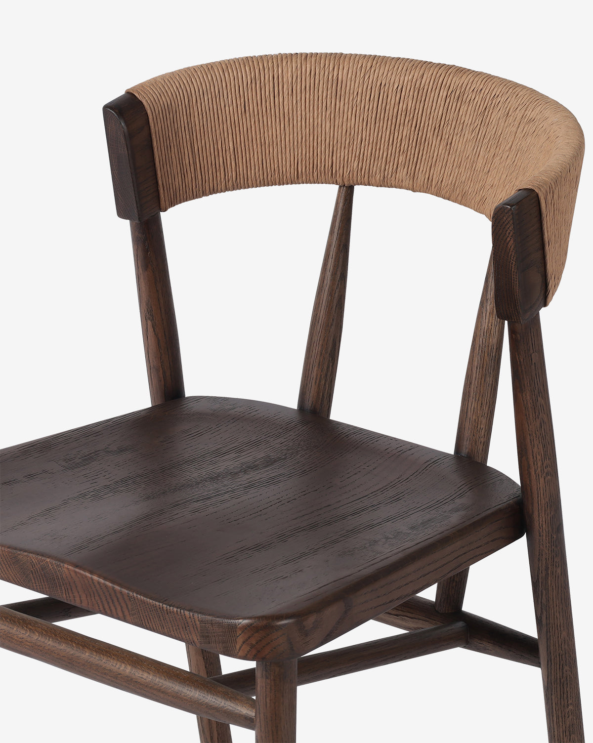 The Ardent Stool by Four Hands features a solid oak frame with dark brown seat and legs, a curved backrest wrapped in light tan woven material, and a modern minimalist design—perfect for any kitchen bar. Vendixs