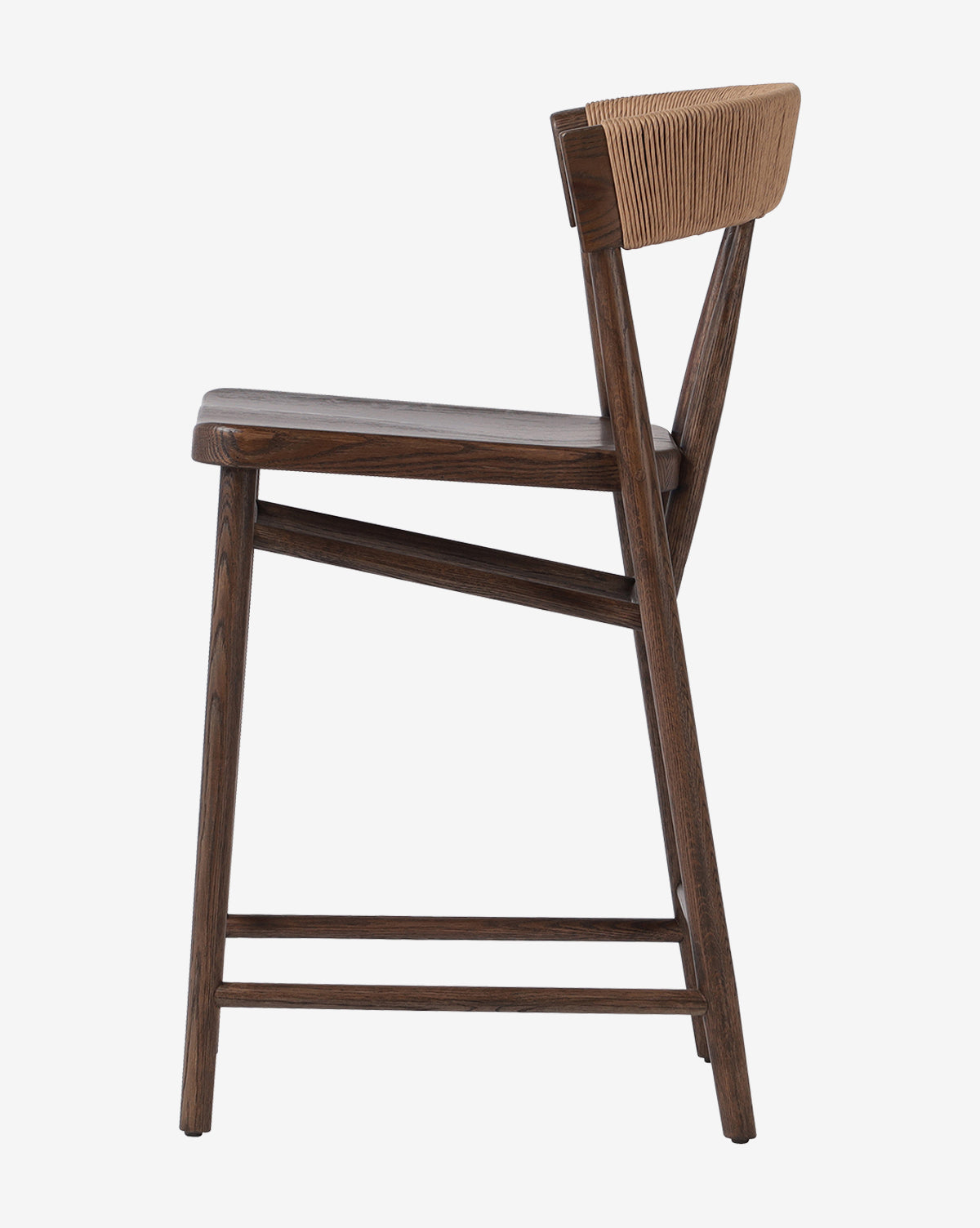 Side view of the Four Hands Ardent Stool featuring a solid oak frame, angled legs, gently curved seat, and a woven light tan backrest—ideal for any modern kitchen bar. Vendixs