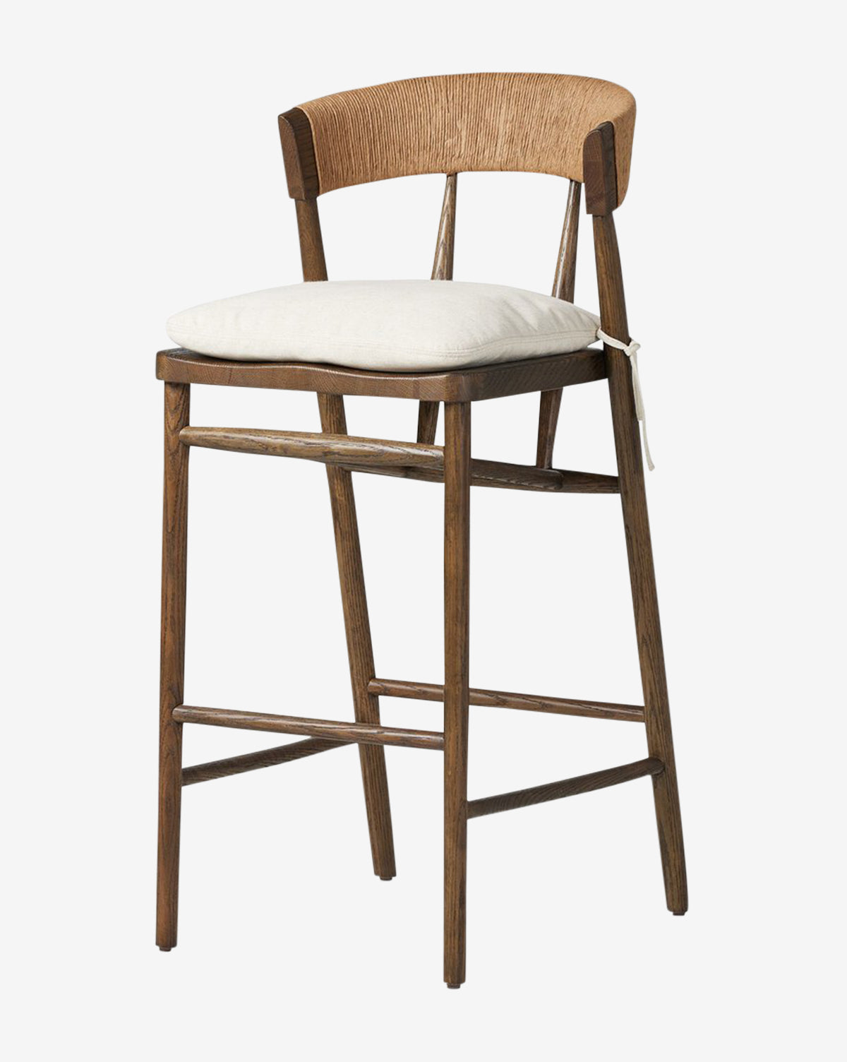 The Ardent Stool by Four Hands features an oak frame, a curved woven natural paper rush backrest, a light cushion tied to the seat, and four straight legs with supports for a timeless blend of natural wood and neutral tones. Vendixs