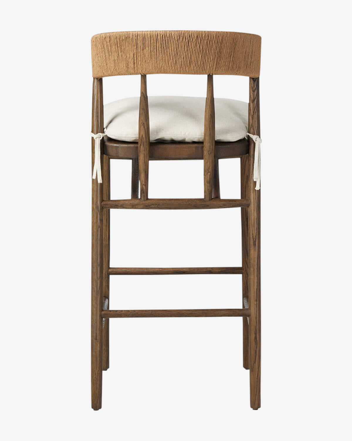 The Ardent Stool by Four Hands features a dark oak frame, a curved light brown backrest, and a light beige cushion with white ties—seen from the back against a white background—making it a stylish choice for your kitchen bar. Vendixs