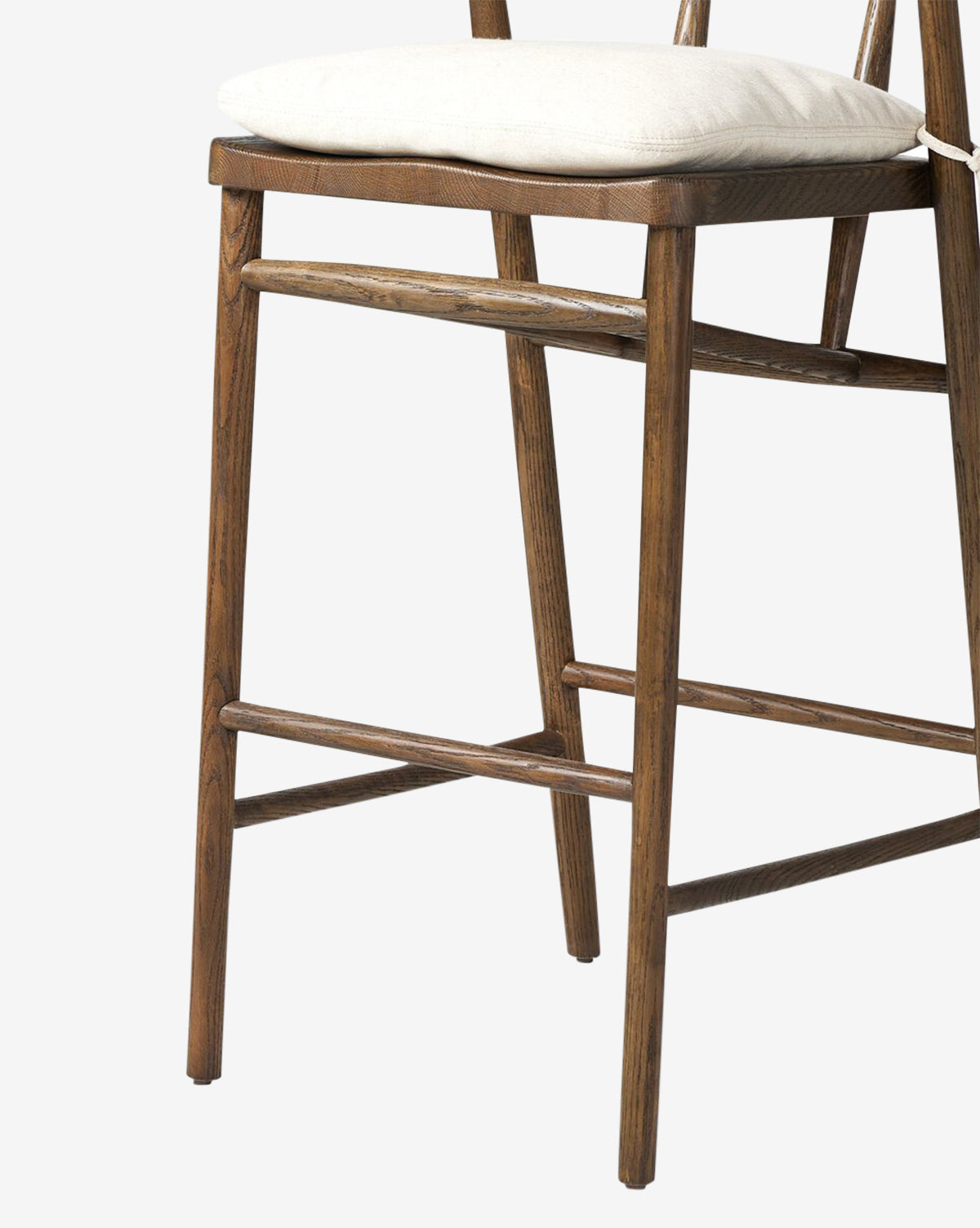 The Four Hands Ardent Stool features a solid oak frame, straight legs, and horizontal support bars with a light cushioned seat—photographed against a white background—ideal for your kitchen bar. Vendixs