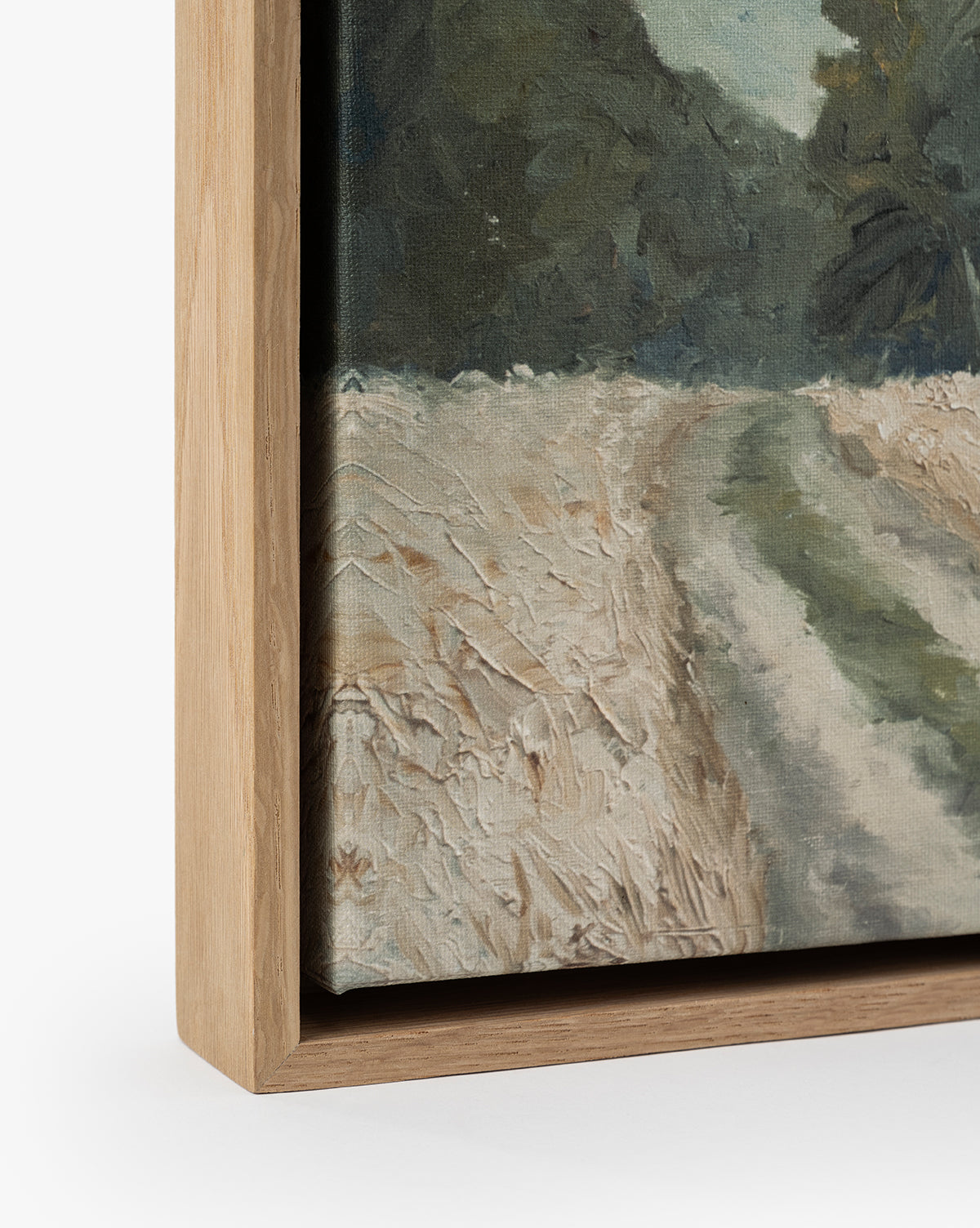 Close-up of Around the Bend, a framed gallery-quality landscape print featuring a textured canvas with a dirt path, grassy area, and trees in natural, muted tones. The light wood frame contrasts with the earthy palette, by Vendixs
