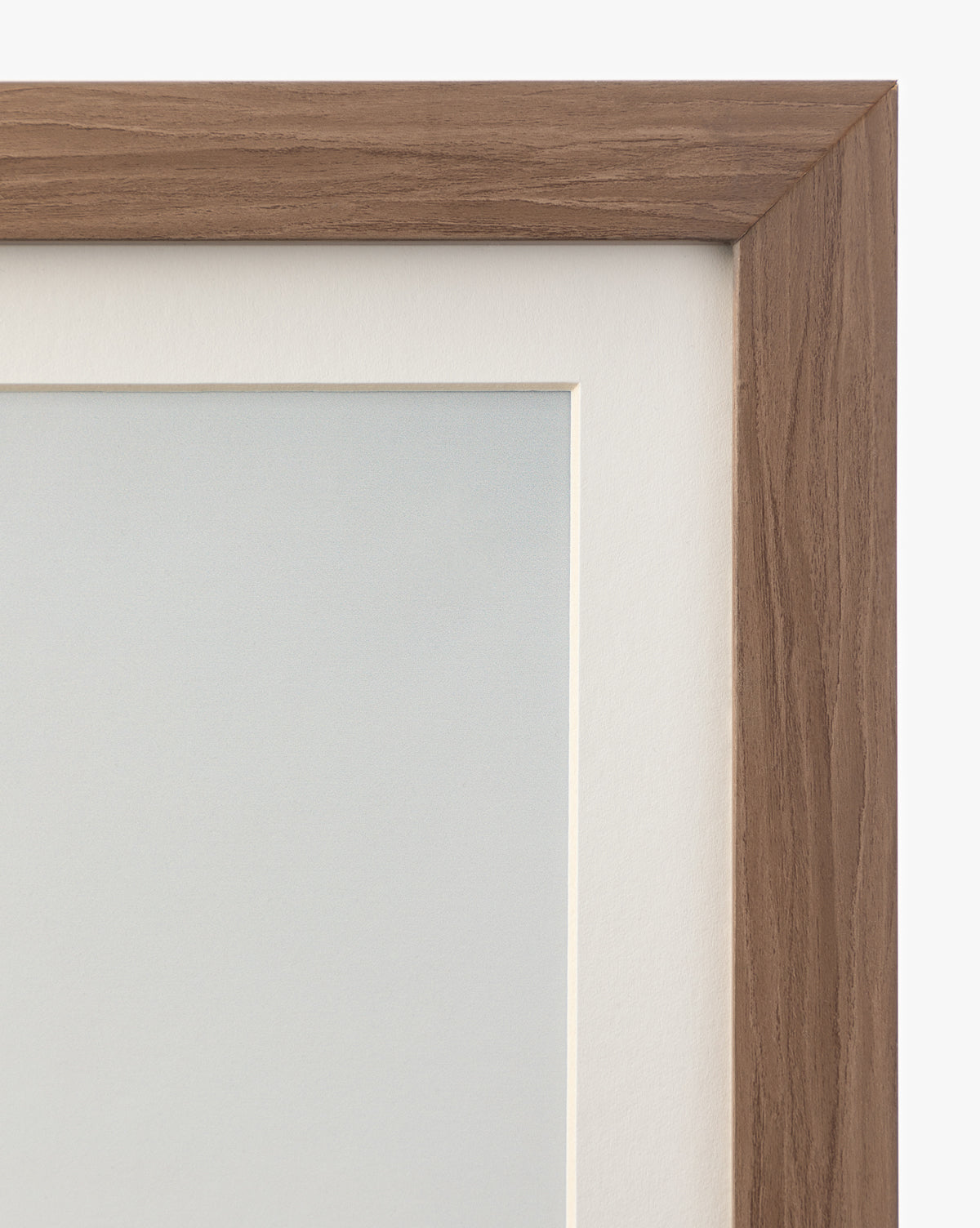 Close-up of the top right corner of a walnut wood frame with a light brown finish, showcasing a white mat board and part of the Autumn Marshes giclee print inside, by Vendixs