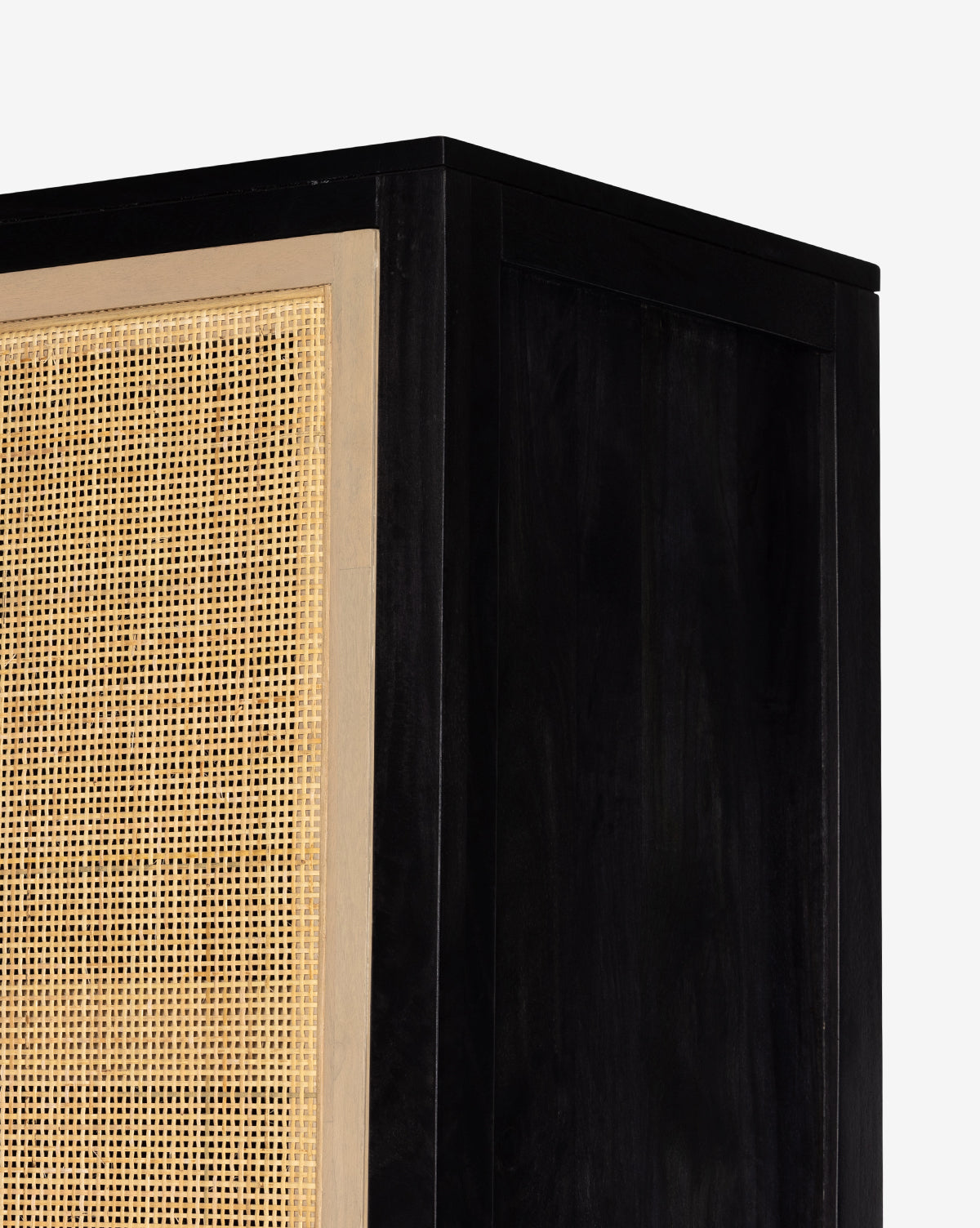 Close-up of the Barney Cabinet in black-washed wood with a natural woven rattan door panel, set against a plain white background; perfect as a modern storage solution with stylish cane doors, by Vendixs