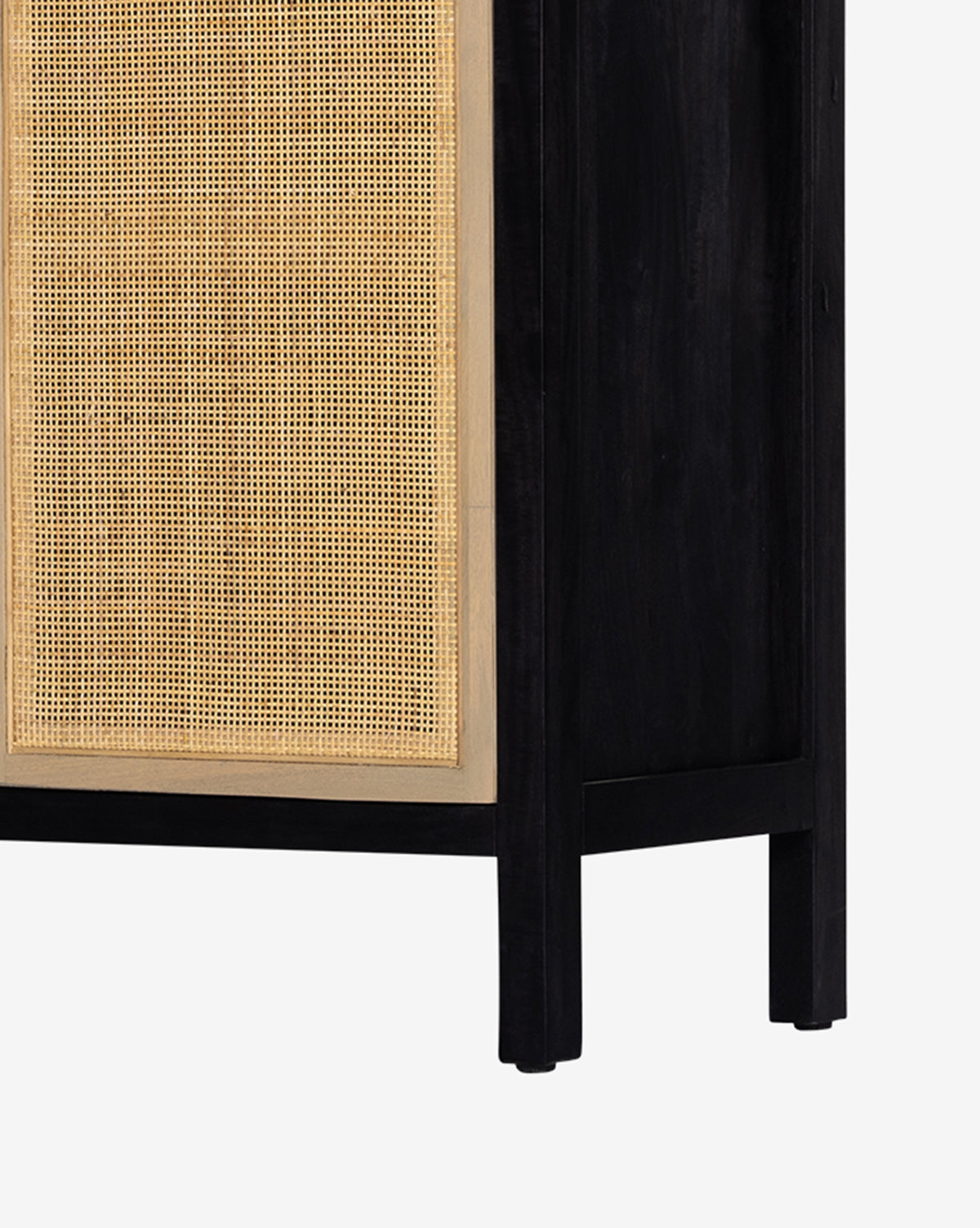 A close-up of the Barney Cabinet showcases its black-washed wood frame and cane doors, emphasizing the striking contrast and rich texture between the woven panels and dark finish, by Vendixs