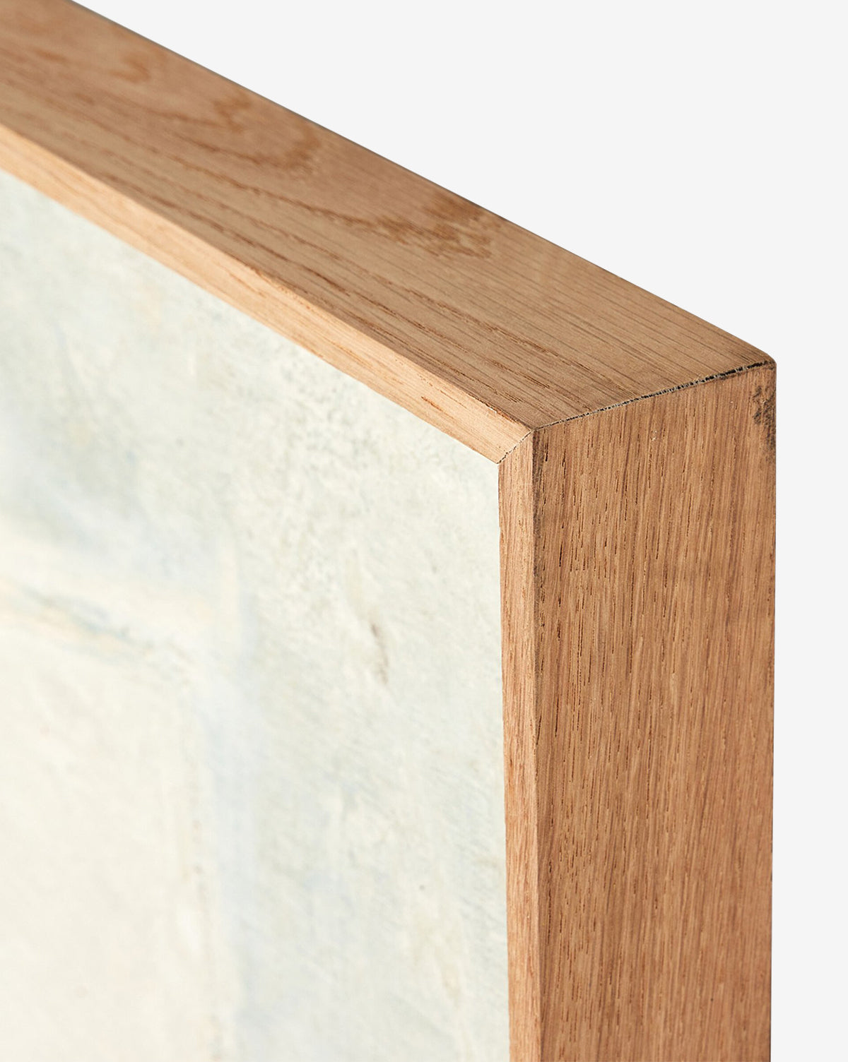 Close-up of the corner of a wooden frame for Basalt by Paul Meyer, featuring light abstract canvas art and emphasizing the natural wood grain and crisp mitered edge, by Vendixs