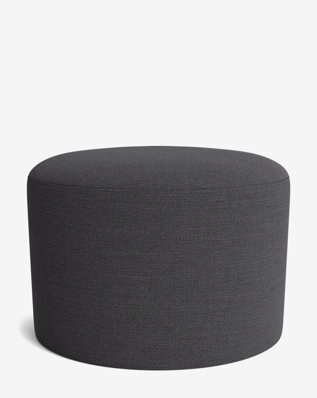 The Makerspalm Bellamy Ottoman features a round, dark gray fabric and minimalist design, displayed on a white background. Its versatile style perfectly complements any modern interior. Vendixs