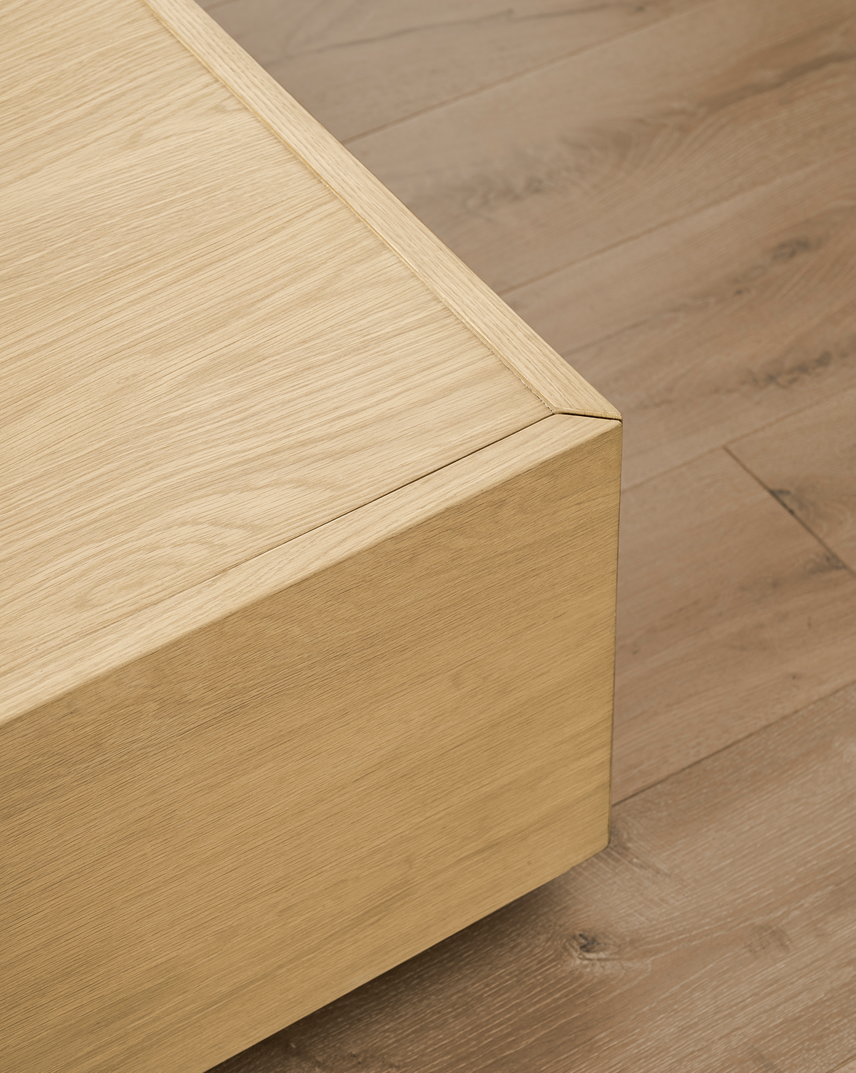 Close-up of the Bentley Coffee Table corner on a wooden floor, showcasing its smooth finish and natural wood grain, complemented by the modern design and quality craftsmanship, by Vendixs