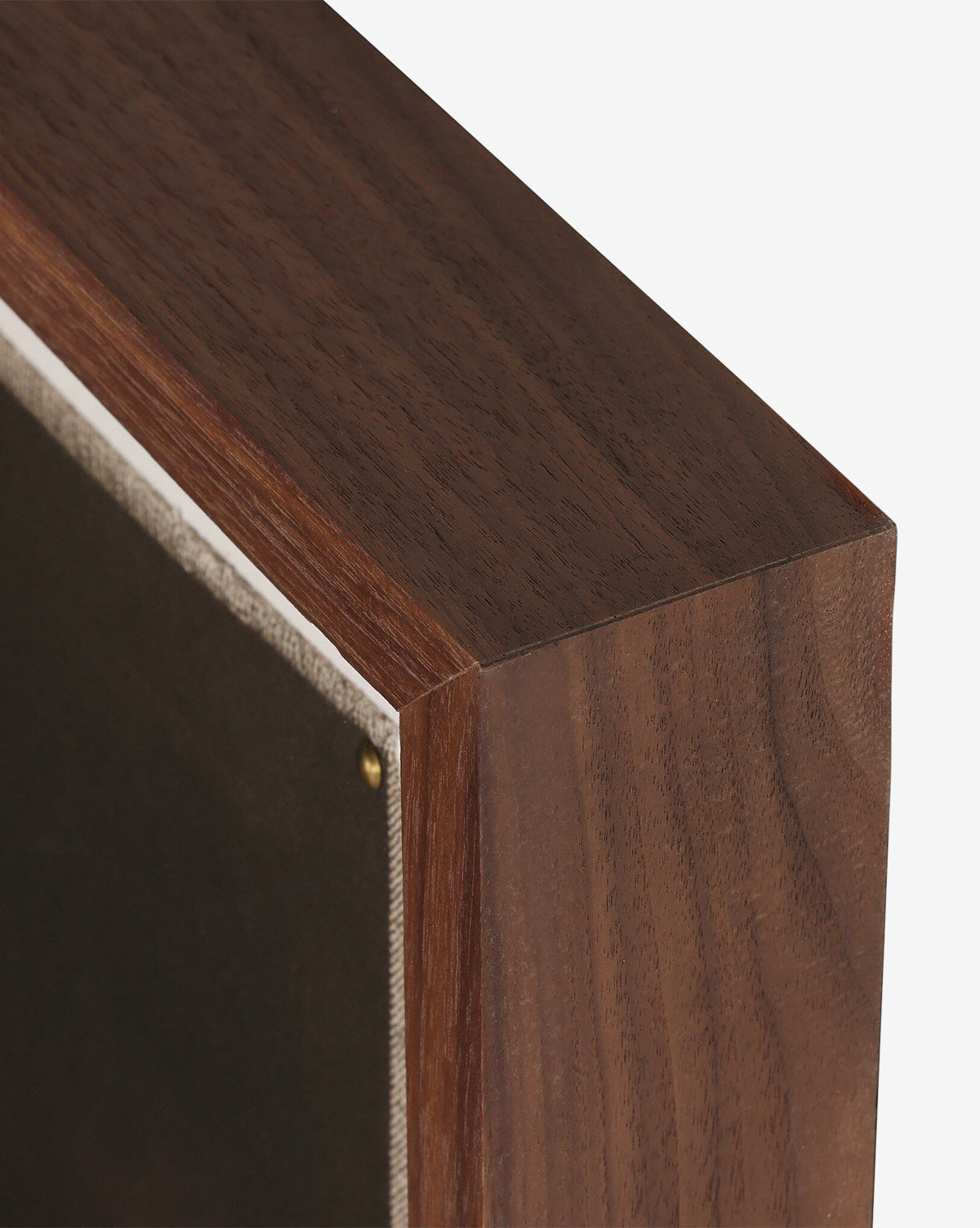 Close-up of a handmade wooden picture frame with a dark finish, securing Bloom II by Brittney Schulz on canvas inside, fastened neatly with a small brass tack, by McGee & Co.