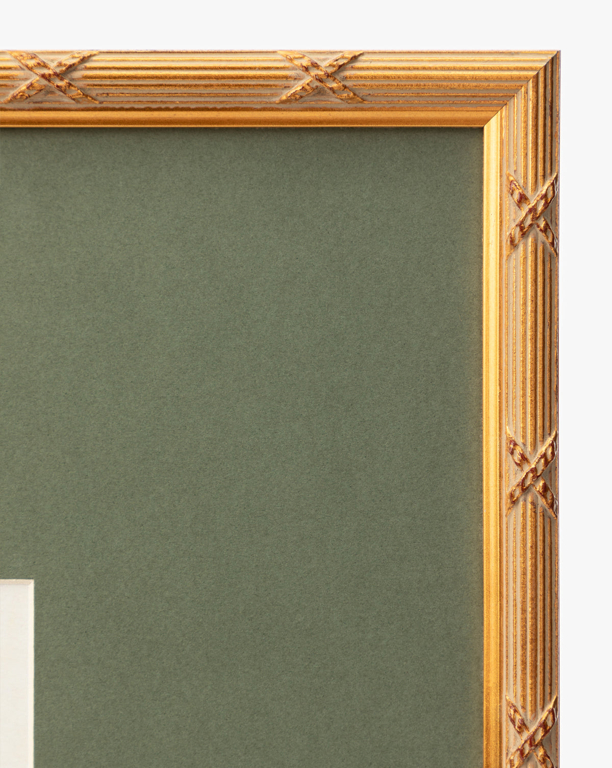 Close-up of the top right corner of the Botanical Grid 2 art frame, featuring X-shaped gold carvings set against a green matte background, by Vendixs