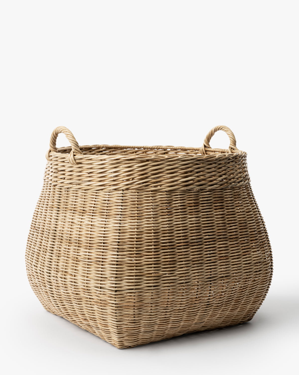 The Boyce Woven Basket is a large, square wicker storage basket with two looped handles on opposite sides, displayed against a plain white background by Vendixs