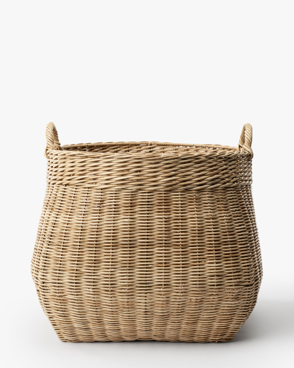 The Boyce Woven Basket is a large, rectangular wicker storage basket featuring two looped handles on each side, displayed against a plain white background by Vendixs