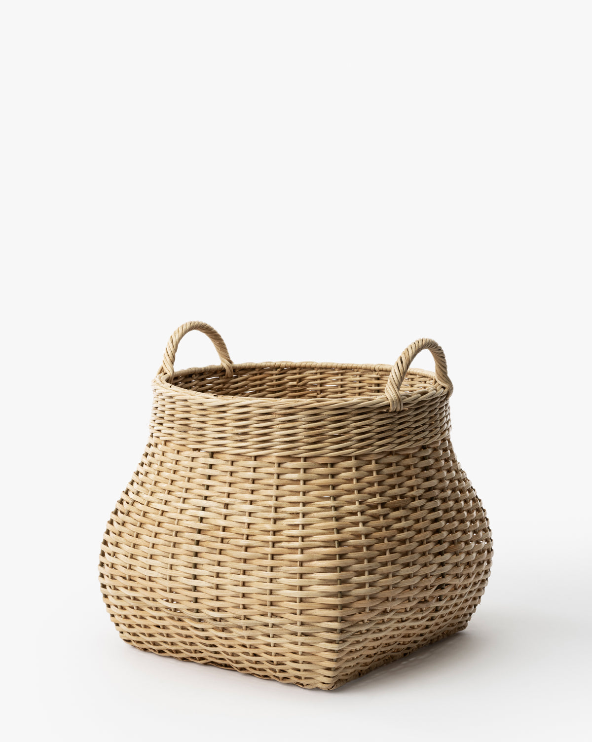 The Boyce Woven Basket is a large, square wicker storage basket featuring two looped handles on opposite sides, shown against a plain white background, by Vendixs