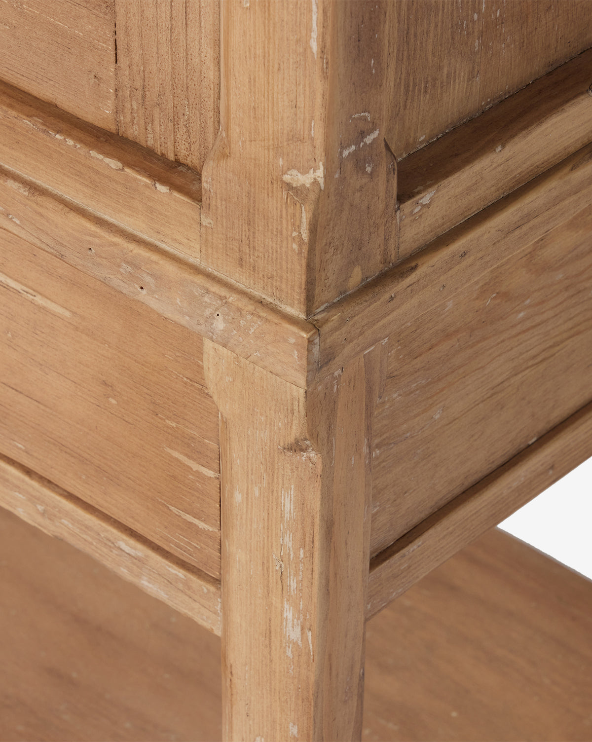 Close-up of the Bryn Cabinet’s corner, crafted from solid pine, highlighting its natural wood grain, detailed joinery, and areas with slight wear and chipped paint for a rustic, weathered look, by Vendixs
