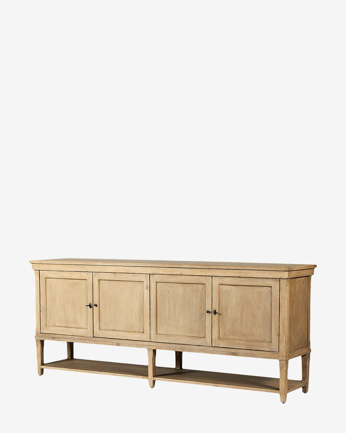 The Bryn Sideboard is crafted from solid pine with a natural finish, featuring four paneled doors, distressed copper hardware, an open lower shelf, and elegant tapered legs in a simple rectangular design, by Vendixs
