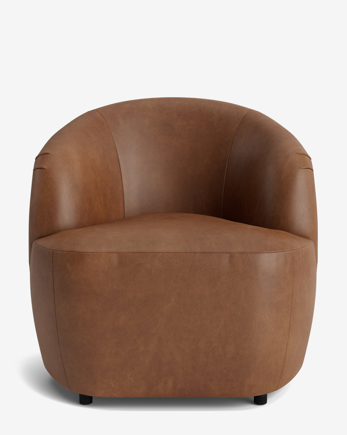 The Byron Chair is a modern, barrel-shaped armchair with a curved back, upholstered in smooth brown leather. It features rounded edges and a low profile, shown against a plain white background by McGee & Co.