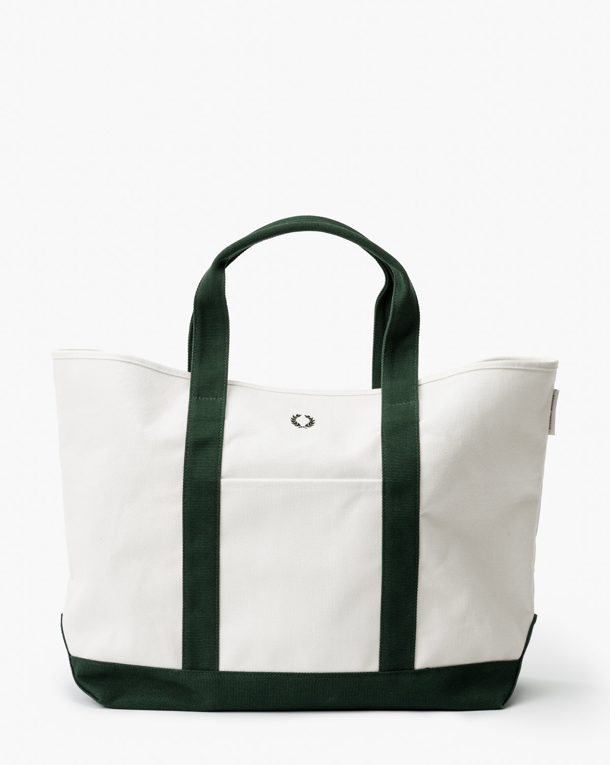 The Canvas Laurel Tote is a spacious white tote with dark green handles, trim, and bottom. It has a small embroidered logo on the front and an exterior pocket for convenience, by Vendixs
