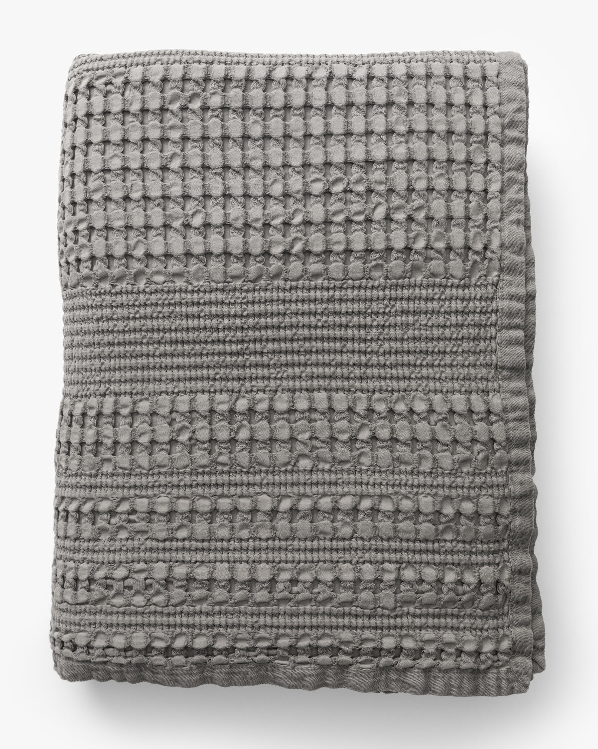 The Penedo Carnel Gray Waffle Blanket features a textured, woven checkered pattern with raised detailing and is shown folded on a white background from Vendixs