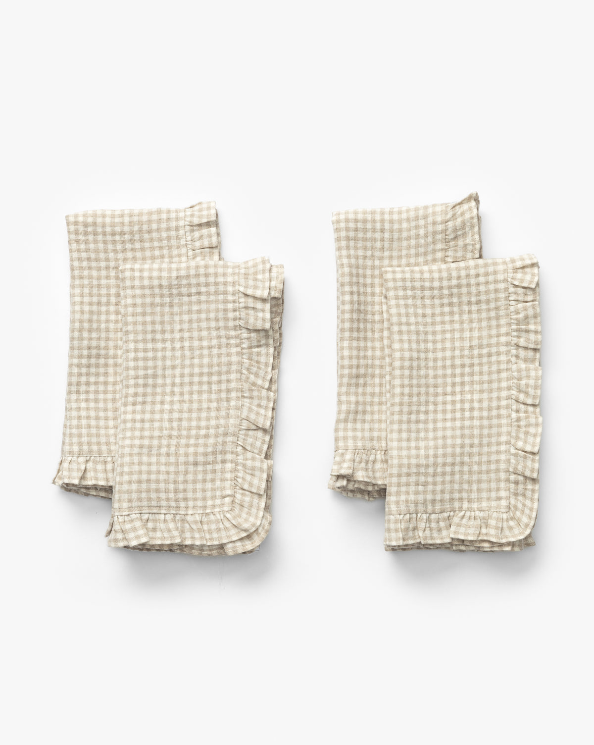 The Catania Linen Napkins (Set of 4) feature a small checkered pattern and ruffled edges, shown folded in two pairs on a white background, by Vendixs